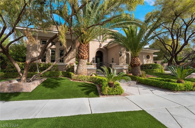 mediterranean / spanish house with a front lawn