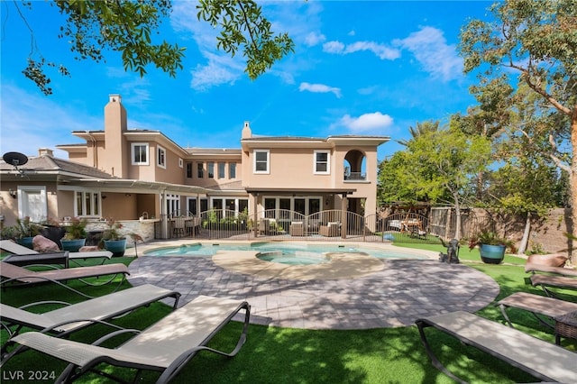 back of property featuring a fenced in pool and a patio area