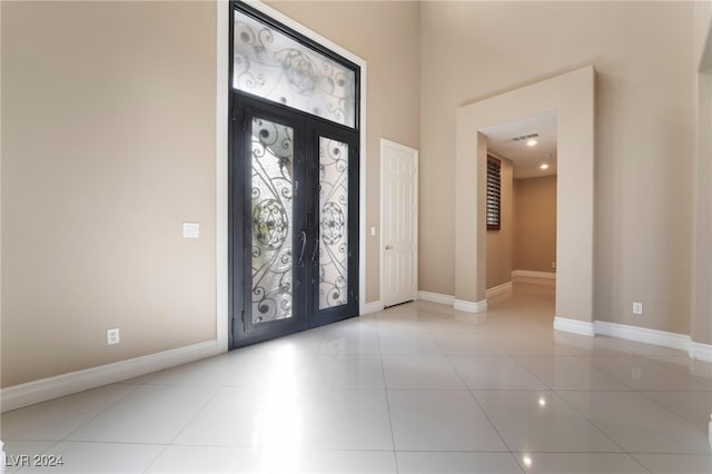 entrance foyer featuring light tile patterned flooring and french doors