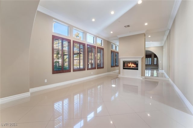 unfurnished living room featuring crown molding and light tile patterned floors