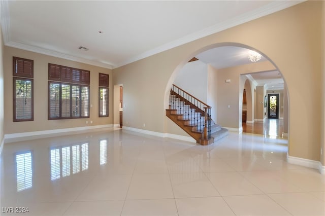 unfurnished room with light tile patterned floors and ornamental molding