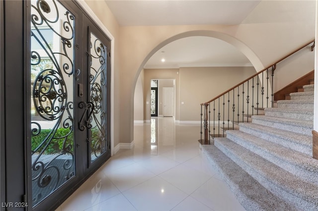 entrance foyer with french doors and light tile patterned flooring