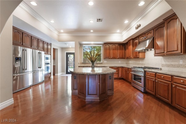 kitchen featuring light stone countertops, a kitchen island, stainless steel appliances, and dark hardwood / wood-style floors