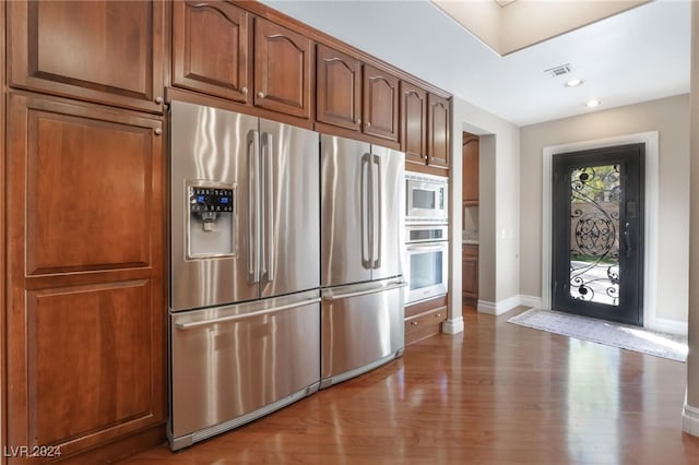 kitchen featuring hardwood / wood-style floors and appliances with stainless steel finishes