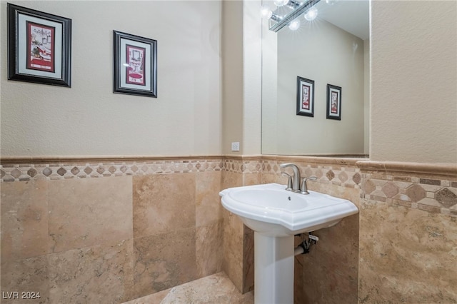 bathroom with tile walls