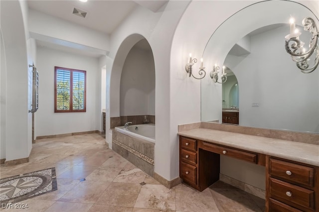 bathroom with vanity and a relaxing tiled tub