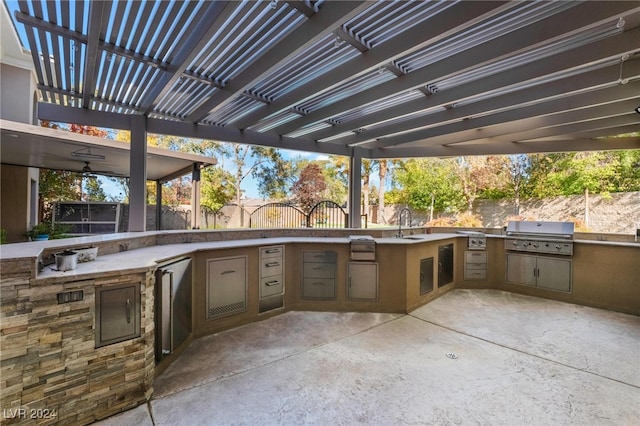 view of patio with a pergola, an outdoor kitchen, grilling area, and sink