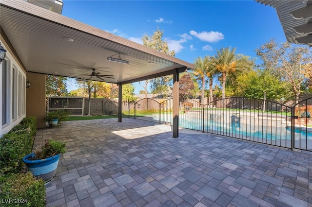 view of patio / terrace with a fenced in pool and ceiling fan