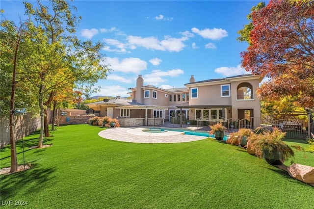 back of property with a patio and a lawn