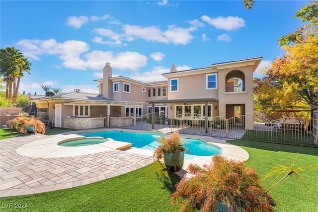 view of swimming pool with a lawn, an in ground hot tub, and a patio