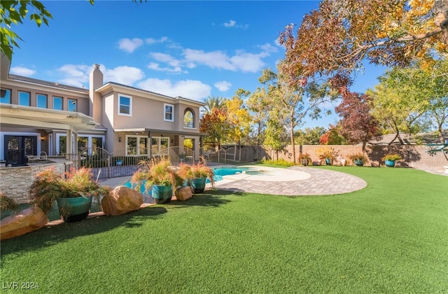 view of yard featuring a patio area and a fenced in pool