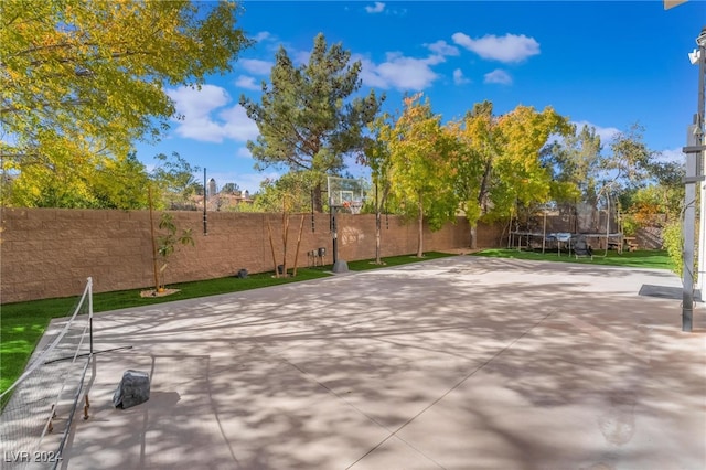 view of patio / terrace featuring basketball court and a trampoline