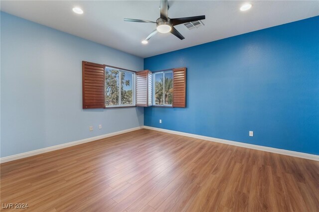 unfurnished room featuring ceiling fan and hardwood / wood-style floors