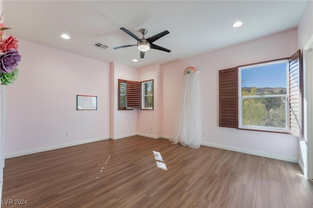 spare room featuring ceiling fan and light hardwood / wood-style floors