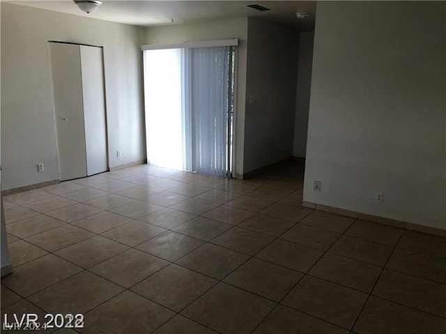 tiled empty room featuring a wealth of natural light