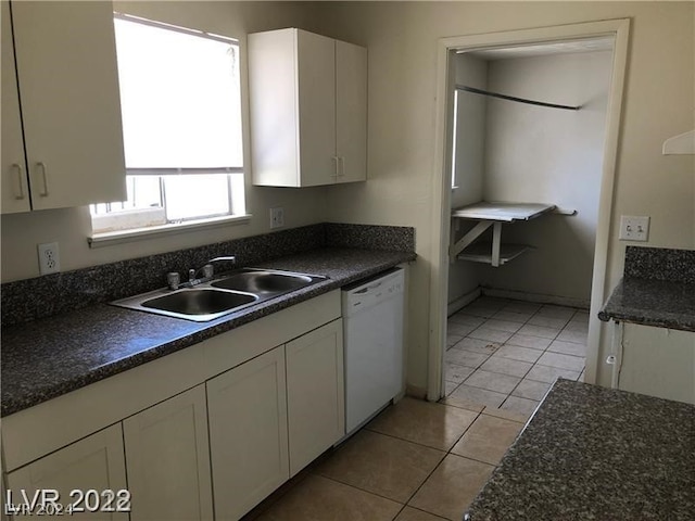 kitchen with white cabinetry, sink, light tile floors, and white dishwasher