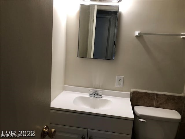 bathroom with toilet and vanity