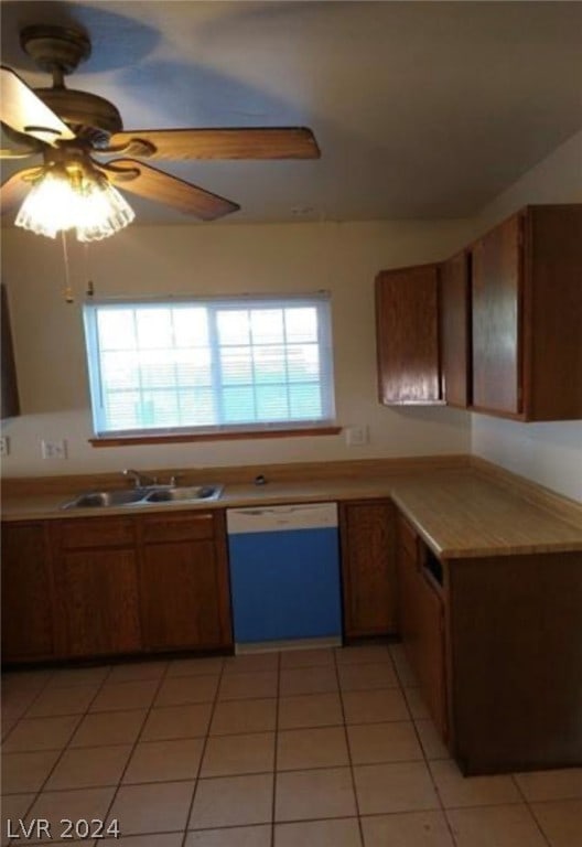 kitchen with sink, white dishwasher, ceiling fan, and a healthy amount of sunlight