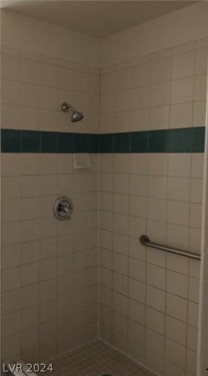 bathroom with a tile shower