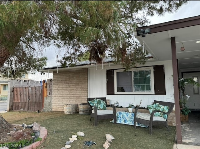 view of property exterior featuring a patio, a lawn, and an outdoor living space