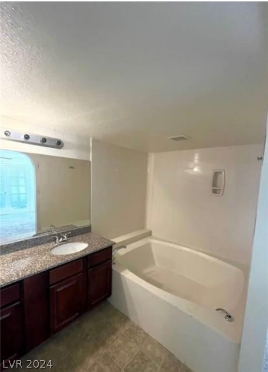 bathroom with large vanity and tile floors