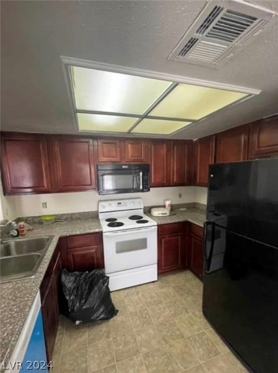 kitchen with light tile floors, black appliances, and sink