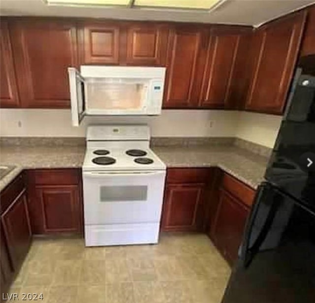 kitchen featuring white appliances and light tile floors