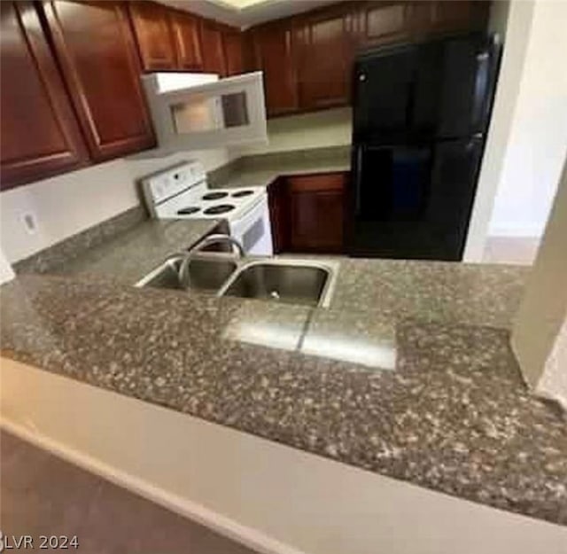 kitchen featuring white appliances and sink