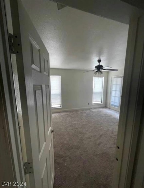 carpeted empty room with ceiling fan