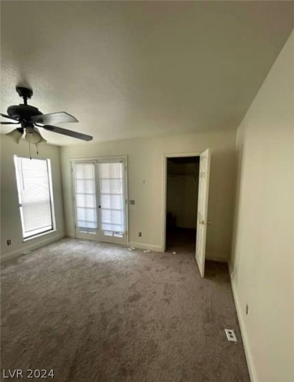 unfurnished bedroom with carpet, ceiling fan, and french doors