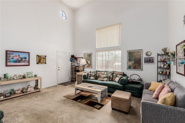 living room featuring carpet floors and a towering ceiling