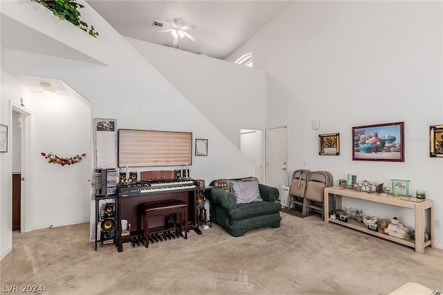 sitting room featuring high vaulted ceiling, ceiling fan, and carpet flooring