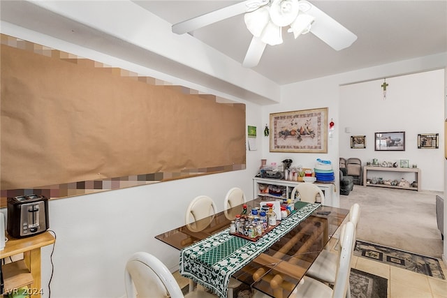 dining area featuring ceiling fan, carpet, and tile patterned floors