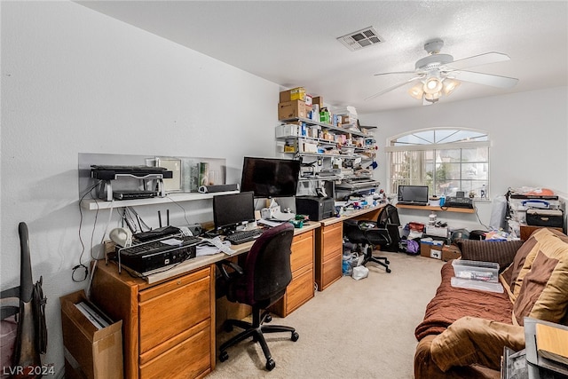 home office featuring a textured ceiling, light colored carpet, and ceiling fan