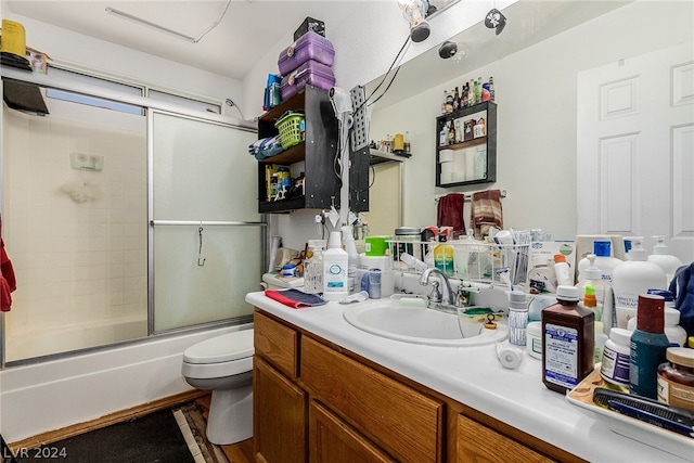 full bathroom featuring hardwood / wood-style floors, bath / shower combo with glass door, toilet, and vanity