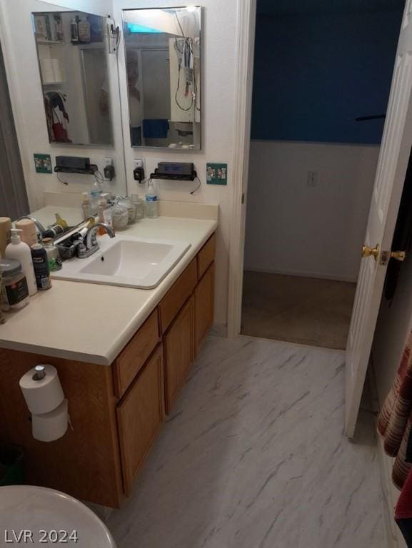 bathroom featuring marble finish floor and vanity