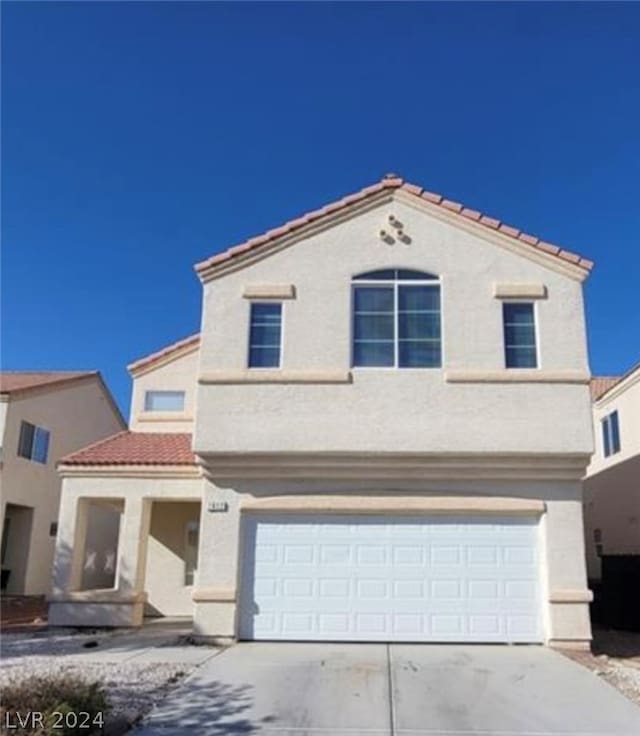 mediterranean / spanish-style home featuring a garage