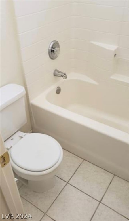 bathroom featuring toilet, tile floors, and shower / tub combination