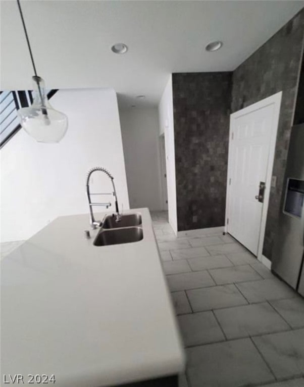 interior space with sink, fridge, and tile floors