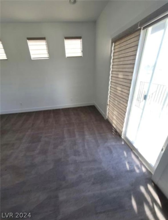 carpeted spare room featuring a healthy amount of sunlight