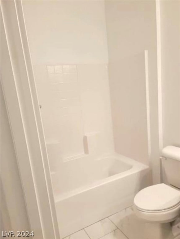 bathroom featuring toilet, tile floors, and shower / tub combination