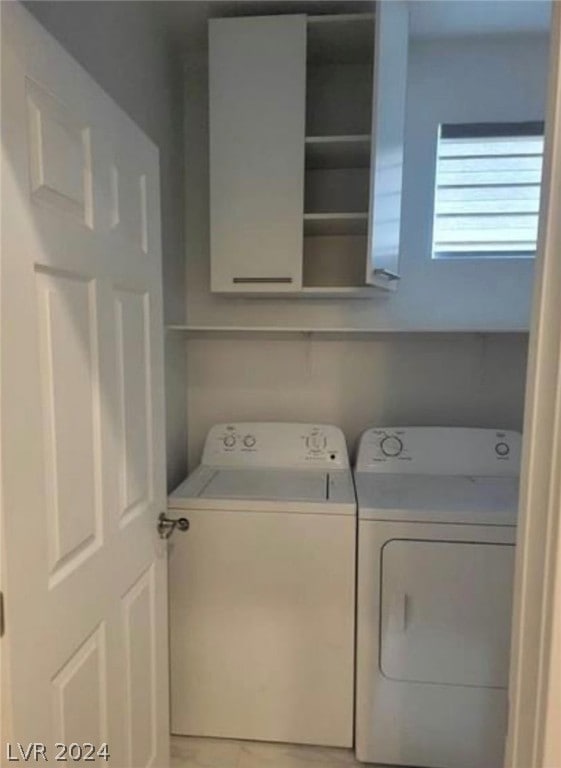 clothes washing area featuring independent washer and dryer