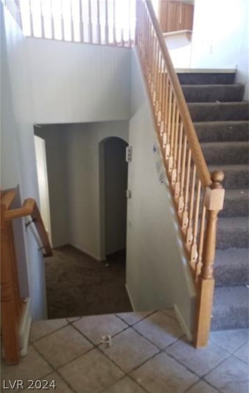 stairs with dark tile flooring