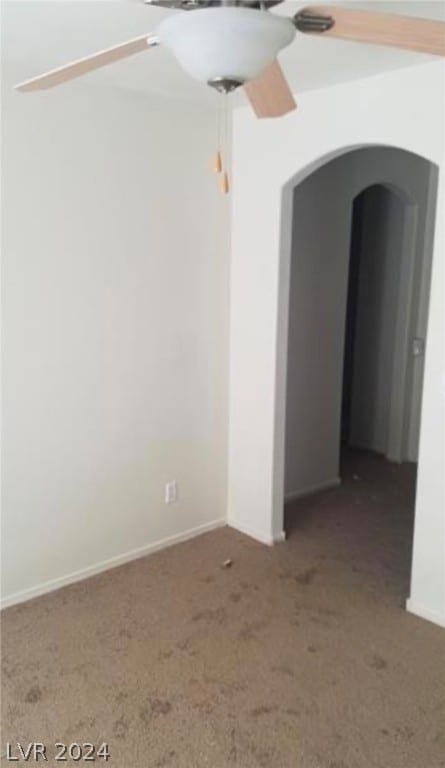 unfurnished room featuring dark colored carpet