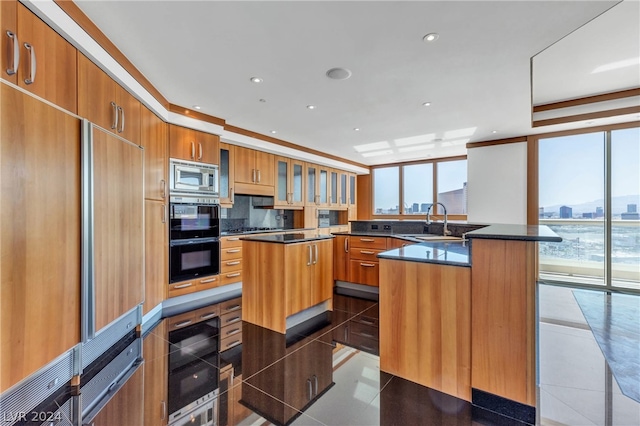 kitchen featuring sink, wine cooler, stainless steel microwave, and a kitchen island