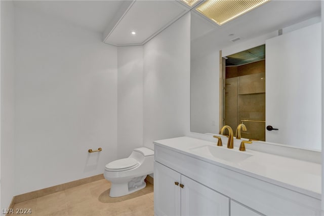 bathroom with vanity, toilet, and tile patterned floors