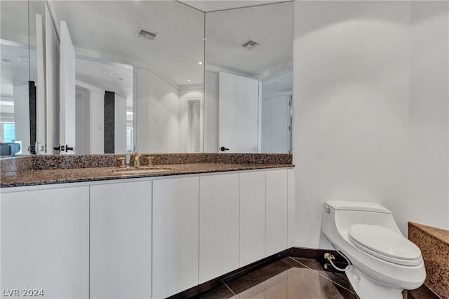 bathroom featuring vanity, toilet, and tile patterned floors