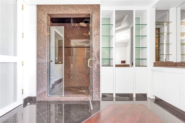 bathroom with vanity and a shower with door