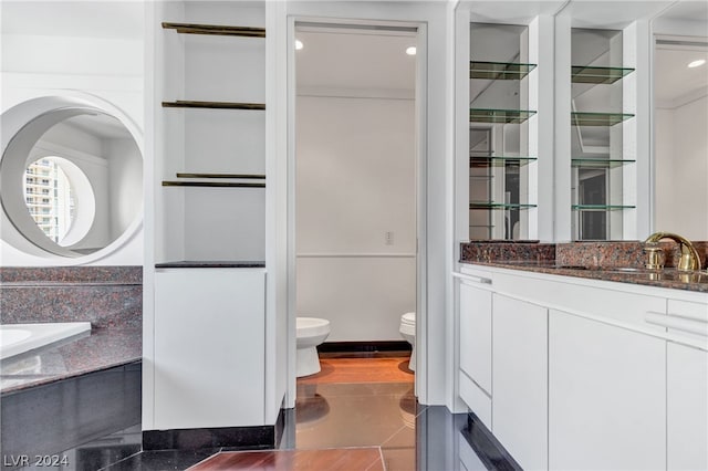 bathroom featuring toilet, vanity, and tile patterned floors