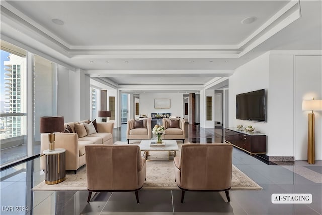 tiled living room featuring a tray ceiling